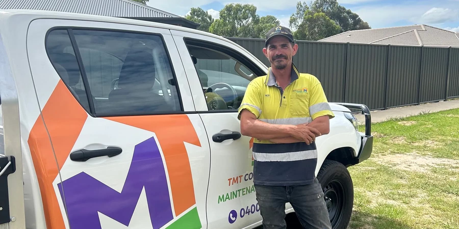 Nick MacDonald, qualified concreter and owner of TMT Concreting & Maintenance, standing beside the TMT-branded ute