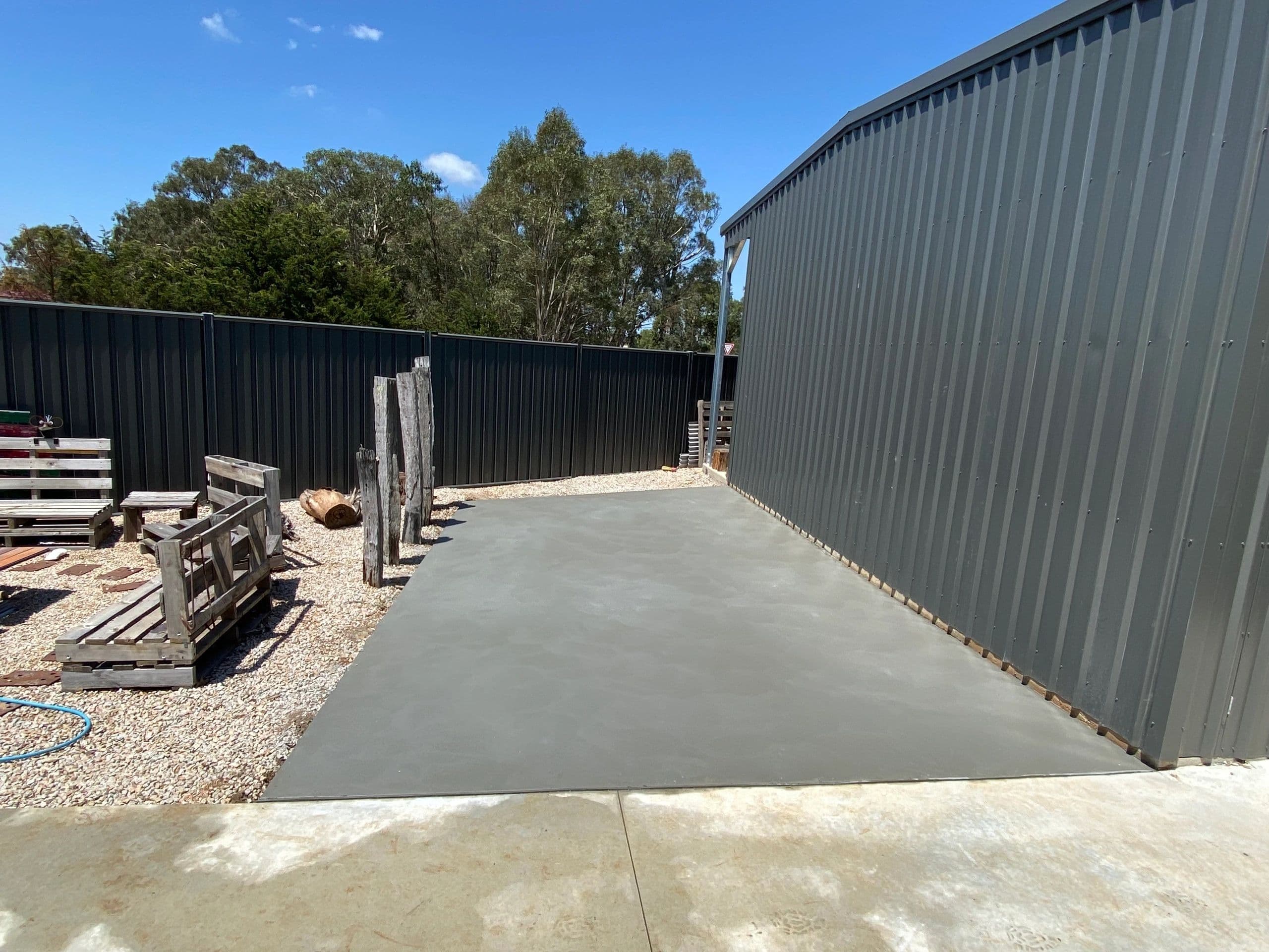 Concrete slab beside a shed · Gippsland — TMT Concreting & Maintenance