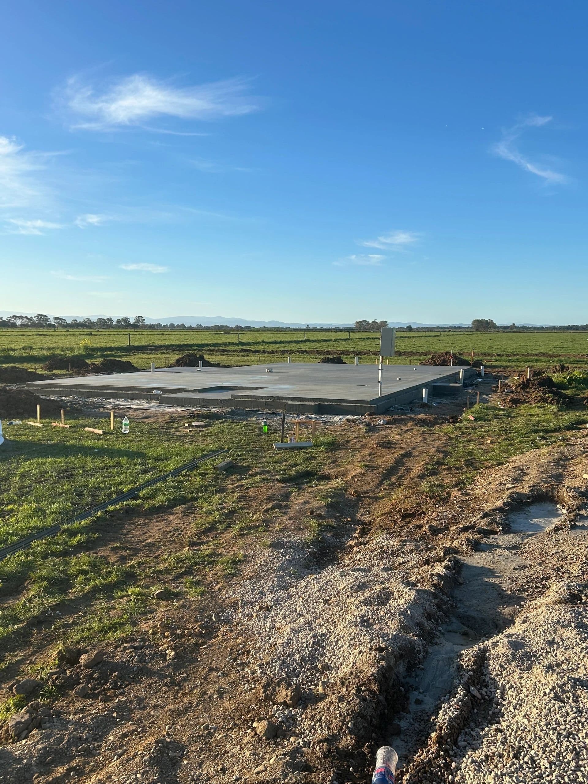 House slab for new build with paddocks in background · Gippsland — TMT Concreting & Maintenance