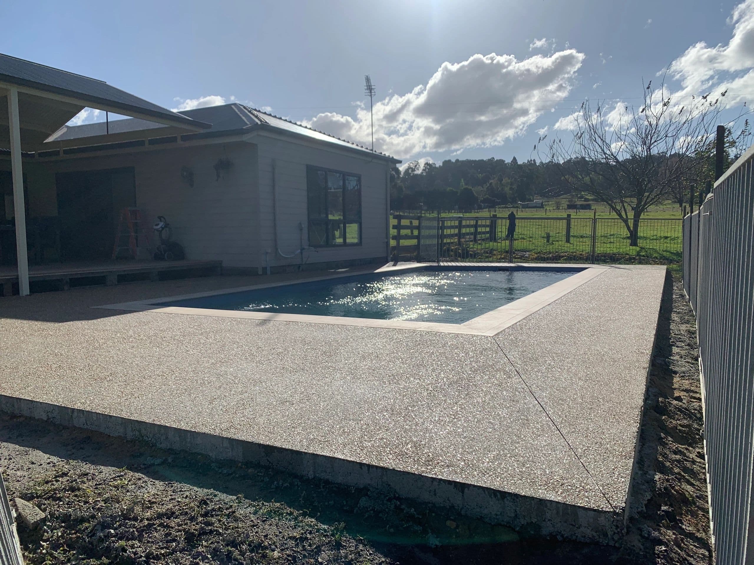 Exposed aggregate pool surrounds · Golden Beach — TMT Concreting & Maintenance